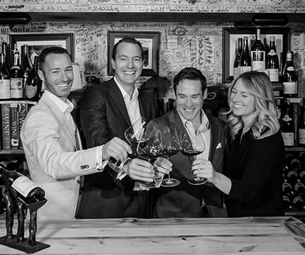 The Little Nell team of sommeliers toasting in The Wine Cellar.