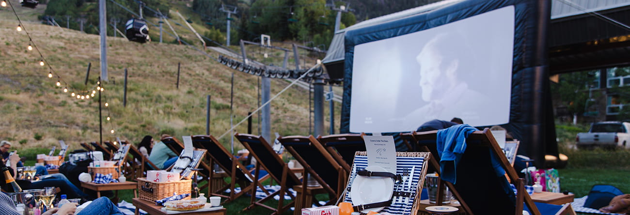 Cinema Under the Stars VIP seating with lawn chairs and food and beverage packages.