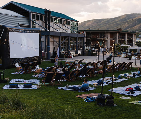Guests in the lawn at the base of Aspen Mountain enjoying Cinema Under the Stars series.