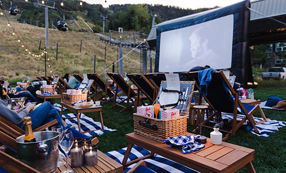 Cinema Under the Stars VIP seating with lawn chairs and food and beverage packages.