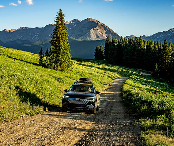 An Audi driving down a dirt road on Aspen Mountain.