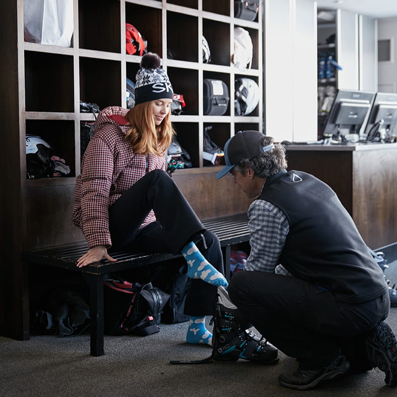 skier being helped by aspen staff member